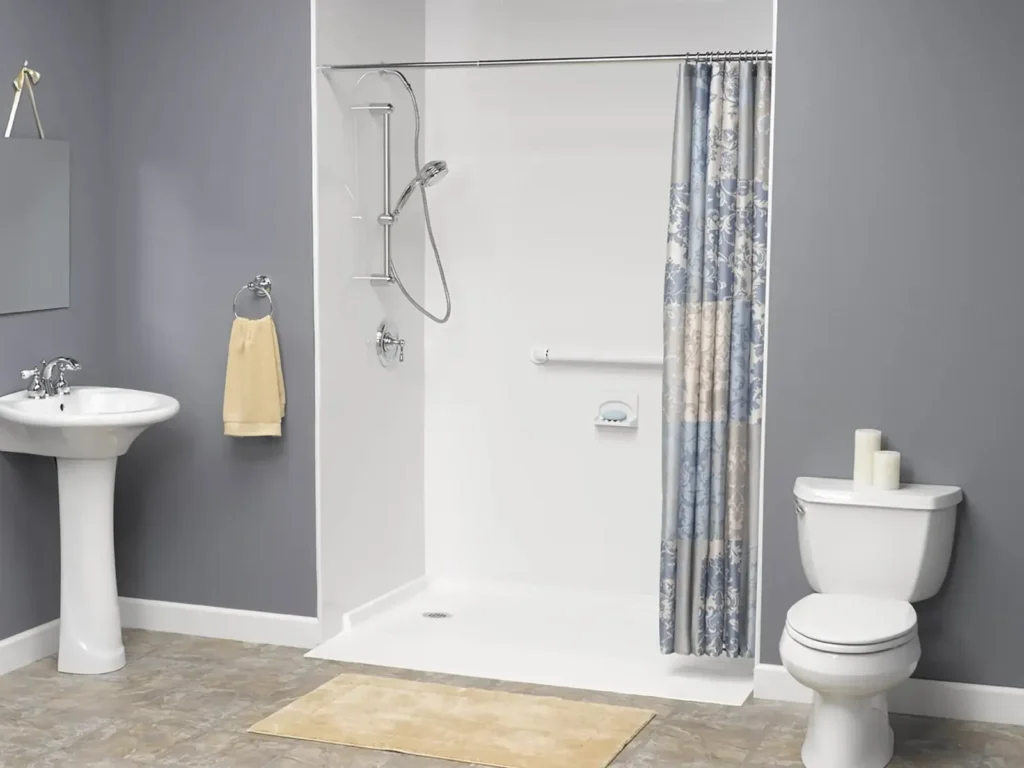 Accessible white shower with curtain handheld showerhead and nearby pedestal sink