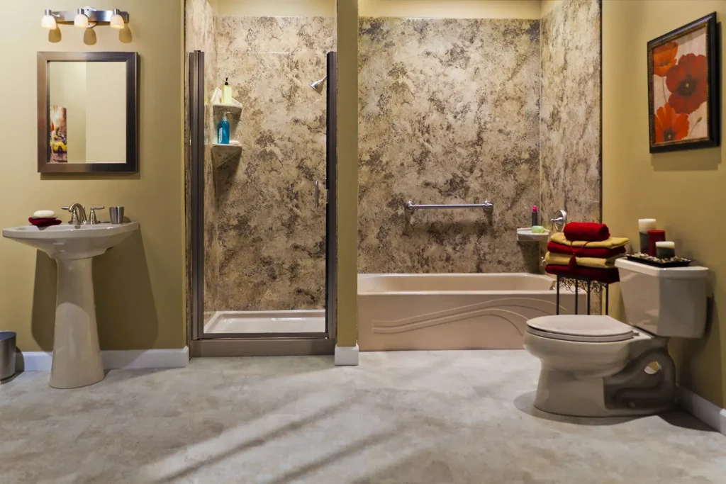 Traditional bathroom featuring decorative tiled shower enclosure pedestal sink and toilet